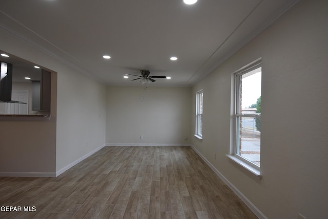 empty room with baseboards, ornamental molding, wood finished floors, and recessed lighting