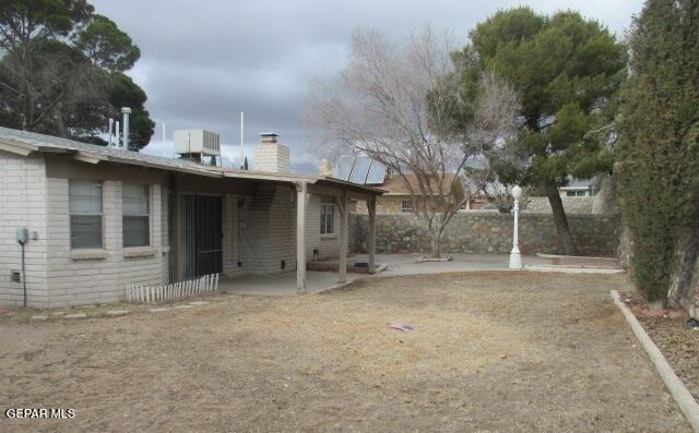 view of yard with cooling unit and a patio area