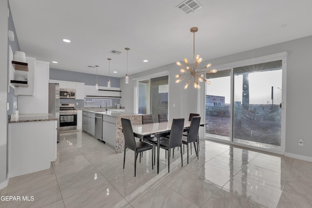 dining room with baseboards, recessed lighting, visible vents, and a notable chandelier