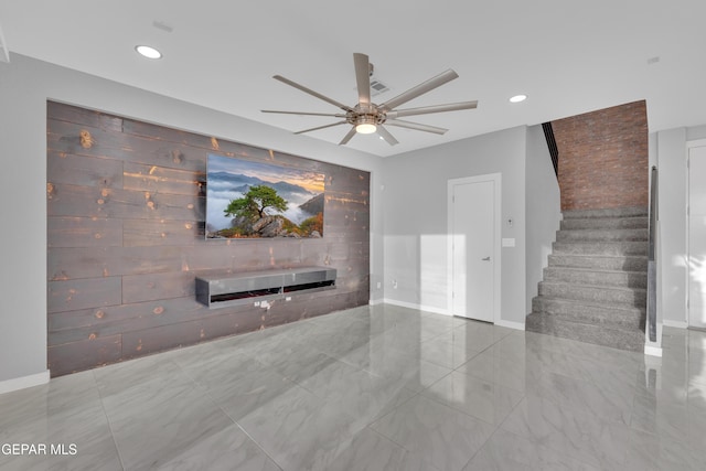 unfurnished living room featuring recessed lighting, ceiling fan, baseboards, and stairs