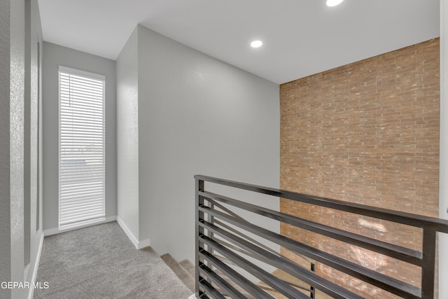 hall with carpet floors, recessed lighting, an upstairs landing, and baseboards