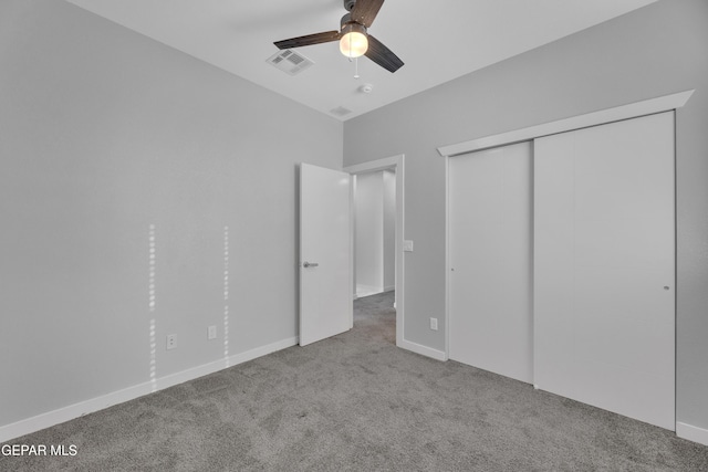 unfurnished bedroom featuring carpet, a closet, visible vents, a ceiling fan, and baseboards