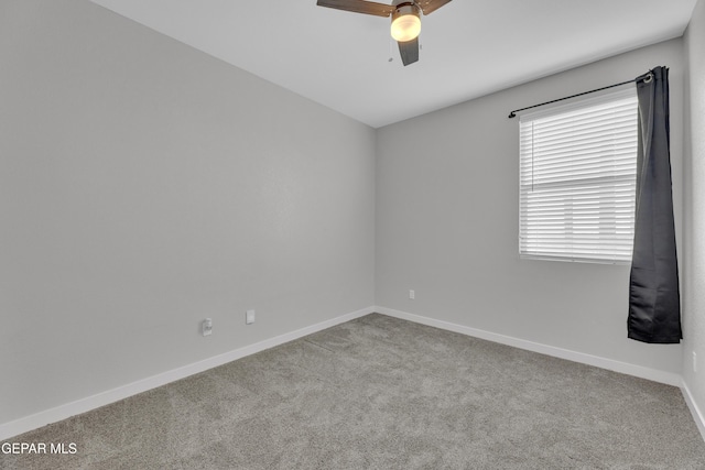 unfurnished room with a ceiling fan, carpet flooring, and baseboards