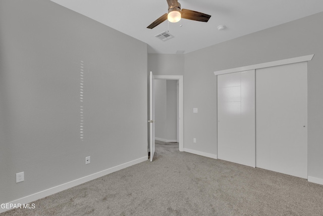 unfurnished bedroom with a closet, visible vents, a ceiling fan, carpet flooring, and baseboards