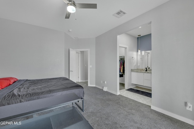 bedroom with a ceiling fan, visible vents, baseboards, a spacious closet, and carpet