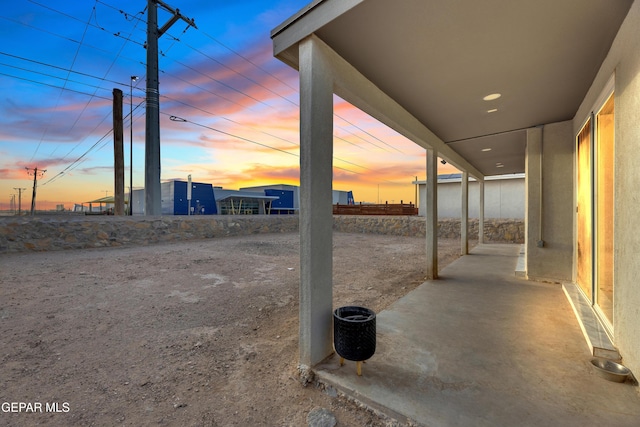 view of patio terrace at dusk