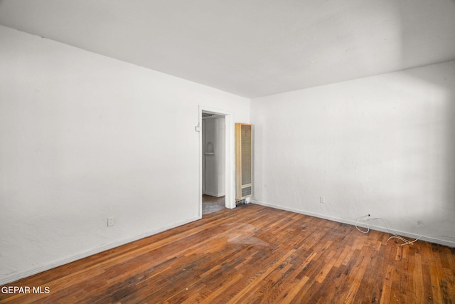 spare room with hardwood / wood-style flooring