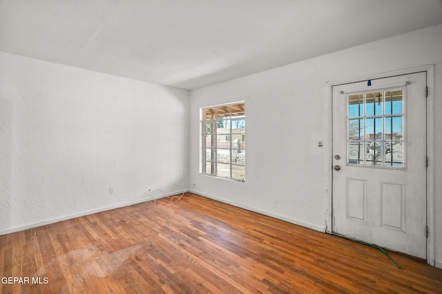 foyer entrance with baseboards and hardwood / wood-style flooring