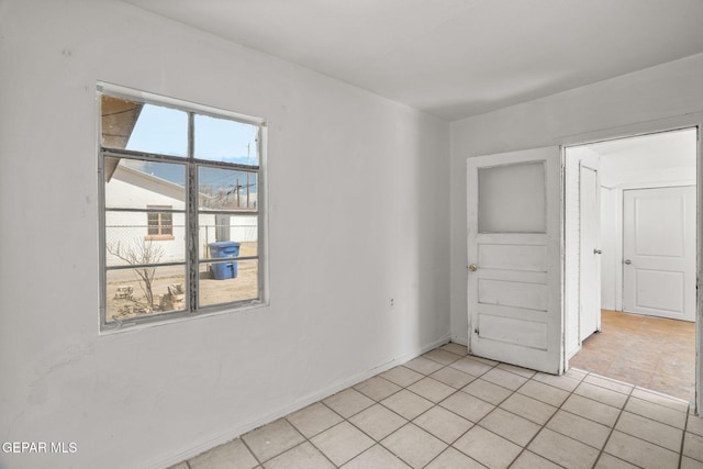 unfurnished room with light tile patterned floors