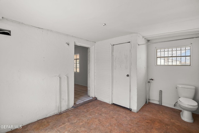 bathroom featuring toilet and a wealth of natural light