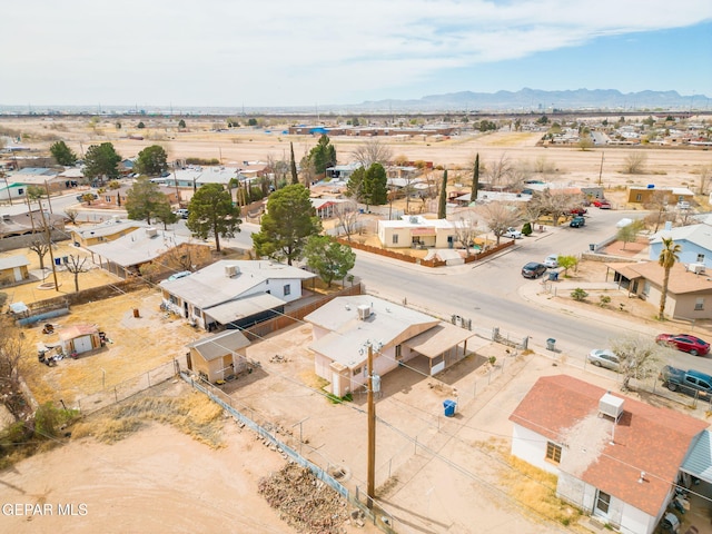 bird's eye view featuring a mountain view, a residential view, and view of desert