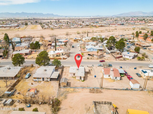 drone / aerial view featuring a mountain view, a residential view, and a desert view