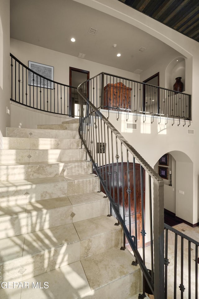 stairway featuring visible vents and recessed lighting