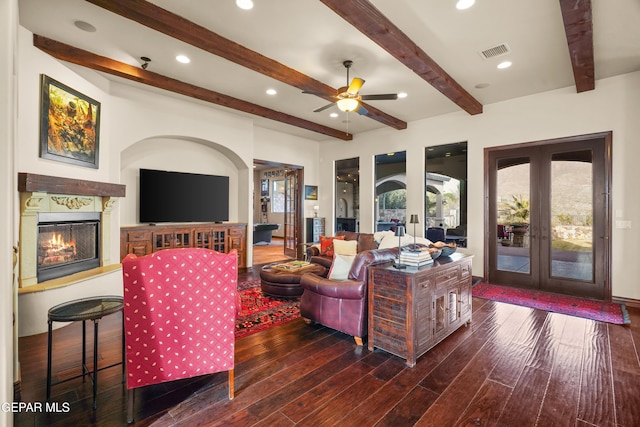 living room with hardwood / wood-style floors, visible vents, a fireplace, french doors, and beamed ceiling