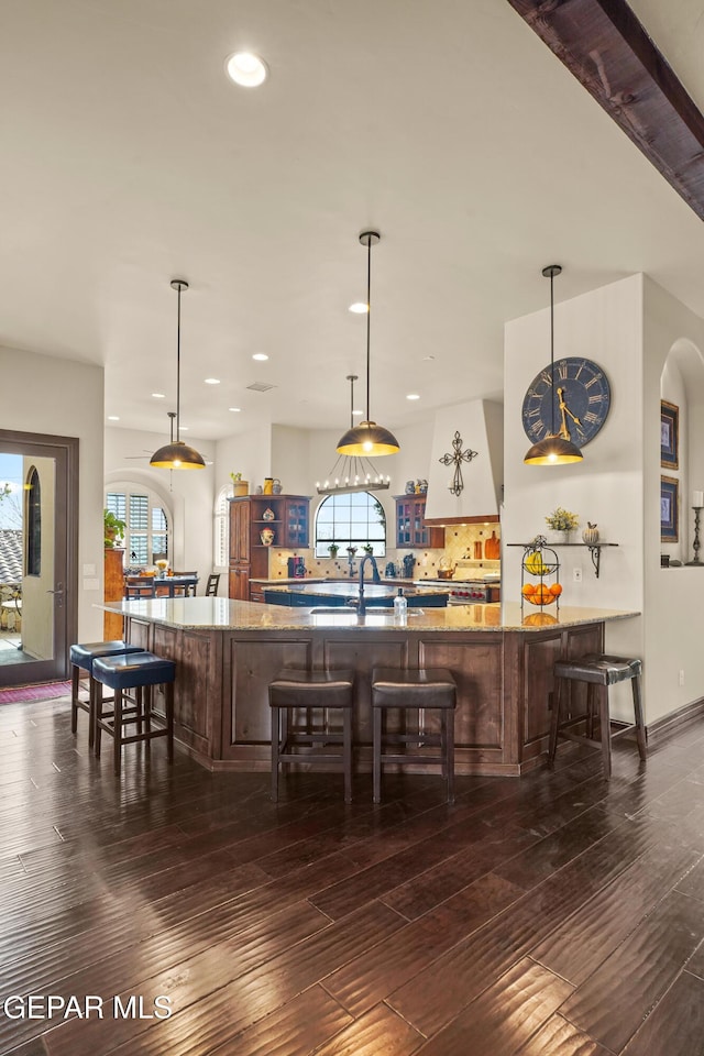 bar featuring recessed lighting, dark wood finished floors, and a sink