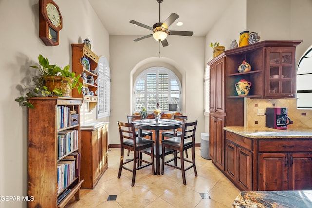 dining room featuring light tile patterned floors, baseboards, and ceiling fan