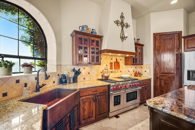 kitchen with light stone counters, appliances with stainless steel finishes, and a sink