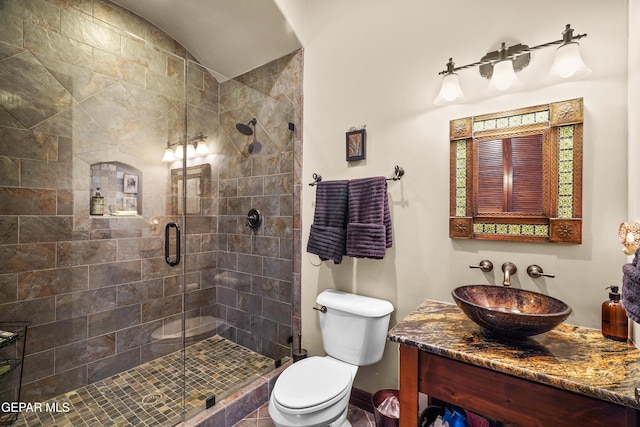 full bathroom featuring vanity, a shower stall, toilet, and lofted ceiling