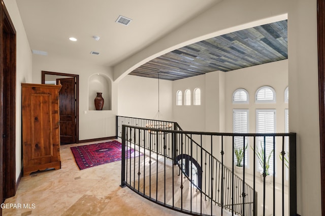 hallway featuring recessed lighting, visible vents, and baseboards
