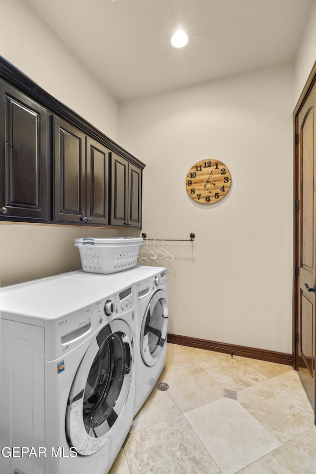 laundry room featuring recessed lighting, cabinet space, light tile patterned flooring, baseboards, and washing machine and clothes dryer
