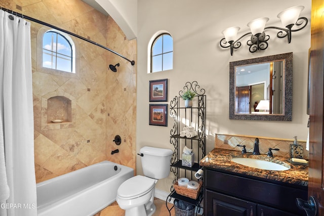 full bath with toilet, vanity, and shower / bath combo