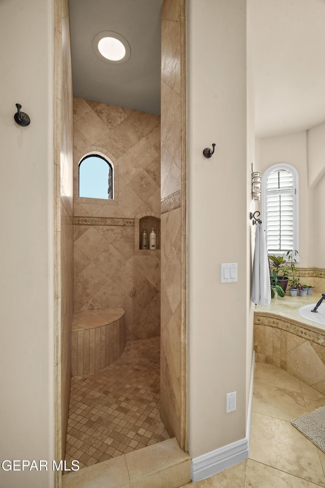 full bath featuring tile patterned floors, tiled shower, and a bath