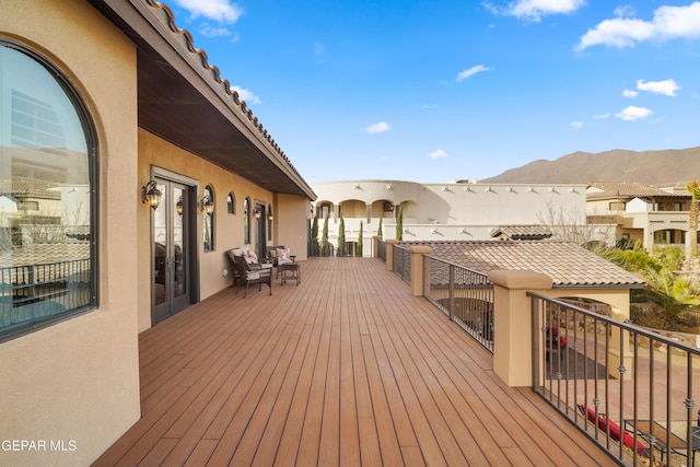 wooden deck with a mountain view