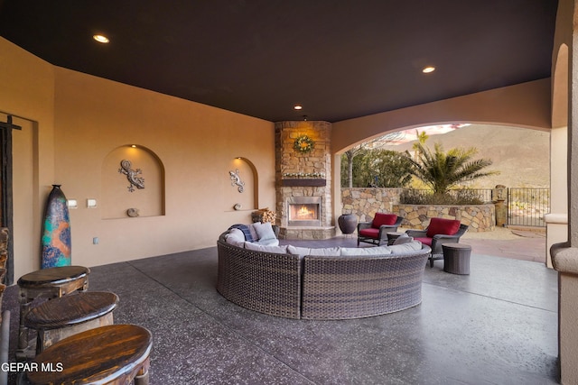 view of patio / terrace featuring fence and an outdoor living space with a fireplace