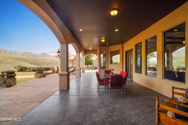 view of patio / terrace with outdoor dining space and a mountain view