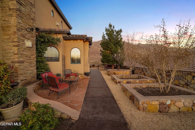 patio terrace at dusk with a garden