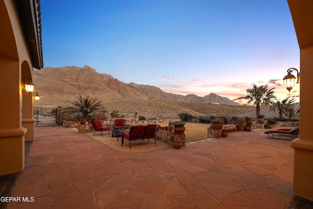 view of patio / terrace featuring a mountain view and fence