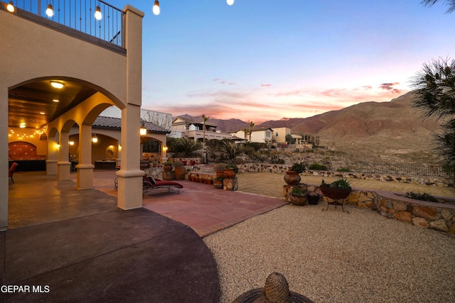 view of patio featuring a balcony and a mountain view