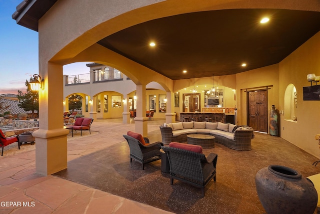view of patio with a balcony and outdoor lounge area