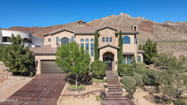 1408 Via Quijano Ln, El Paso, TX 79912 - mediterranean / spanish home featuring stucco siding, a tile roof, driveway, and a mountain view