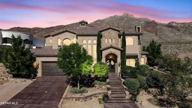 1408 Via Quijano Ln, El Paso, TX 79912 - mediterranean / spanish-style house with concrete driveway, a tiled roof, stucco siding, and a mountain view