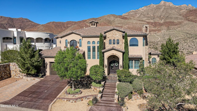 1408 Via Quijano Ln, El Paso, TX 79912 - mediterranean / spanish house with stucco siding, a tiled roof, and driveway