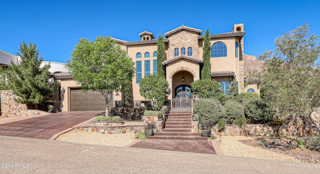 1408 Via Quijano Ln, El Paso, TX 79912 - mediterranean / spanish-style house featuring stucco siding, a tile roof, concrete driveway, and a chimney