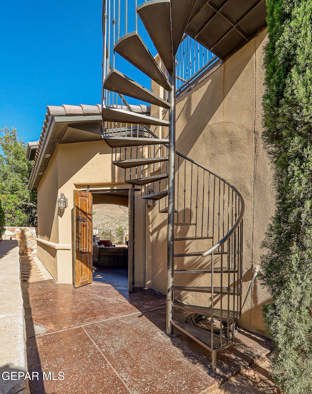 1408 Via Quijano Ln, El Paso, TX 79912 - view of property exterior with stairway and stucco siding