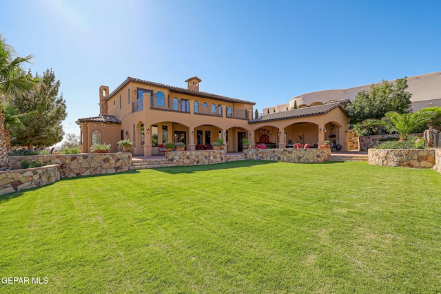 1408 Via Quijano Ln, El Paso, TX 79912 - back of house featuring a chimney, stucco siding, a lawn, and a tile roof