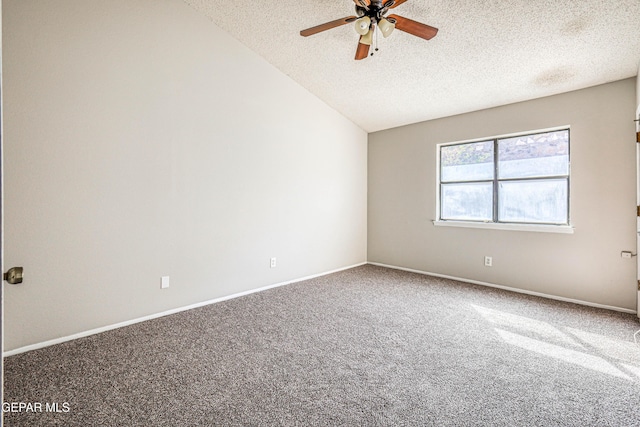 carpeted empty room featuring lofted ceiling, a ceiling fan, baseboards, and a textured ceiling