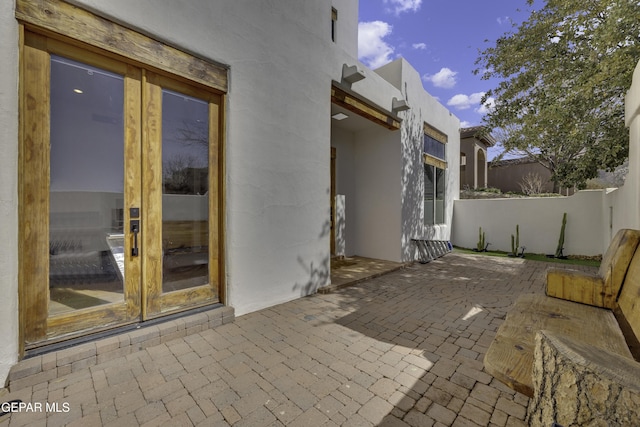 view of patio with french doors and fence