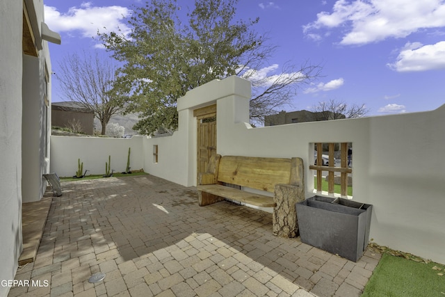 view of patio featuring fence