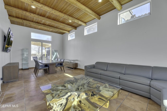 living room with beamed ceiling, tile patterned flooring, wood ceiling, and baseboards