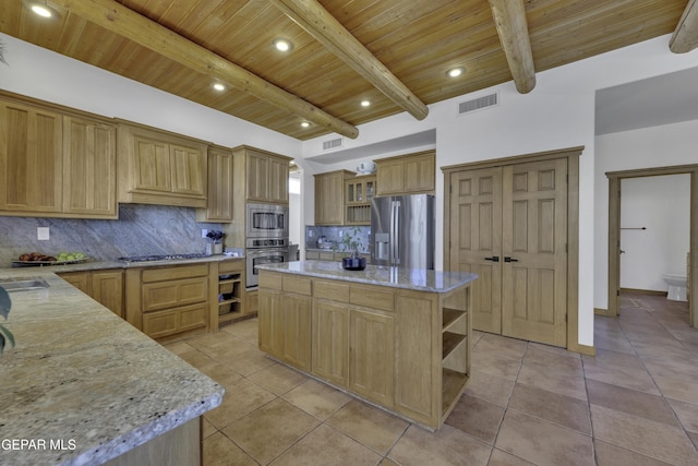 kitchen with light stone counters, open shelves, stainless steel appliances, tasteful backsplash, and a kitchen island