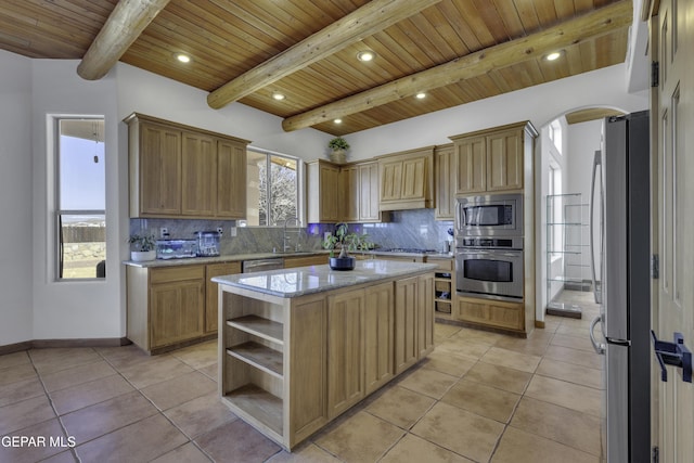 kitchen with light tile patterned floors, tasteful backsplash, and appliances with stainless steel finishes