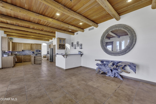 interior space with wooden ceiling, baseboards, visible vents, and beam ceiling