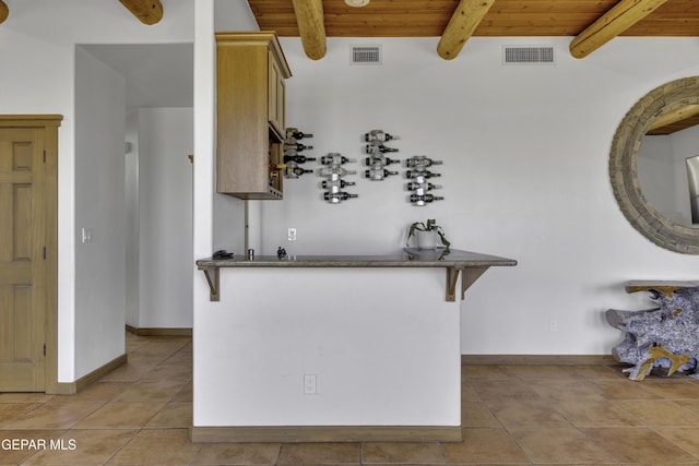 kitchen with wooden ceiling, visible vents, beamed ceiling, and light tile patterned floors