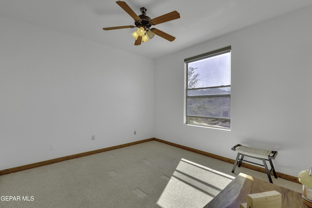 unfurnished room featuring carpet, baseboards, and a ceiling fan