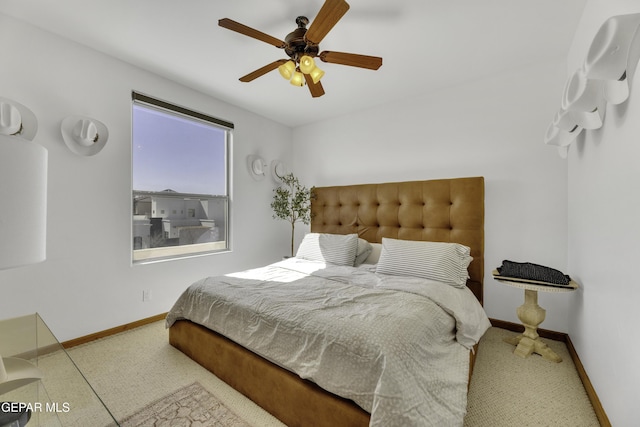 bedroom featuring carpet, a ceiling fan, and baseboards