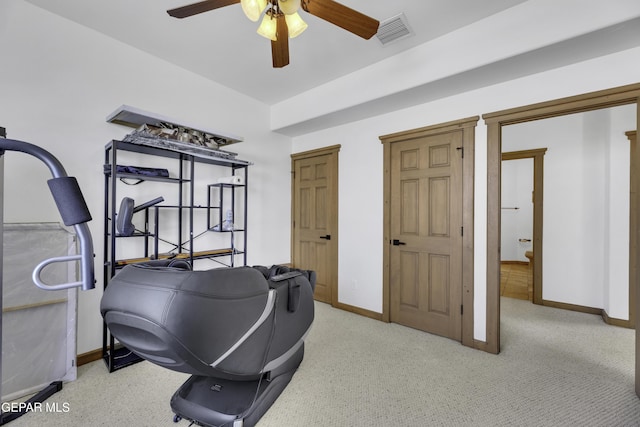 workout area featuring baseboards, visible vents, and ceiling fan